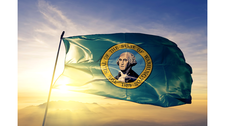 Washington state of United States flag textile cloth fabric waving on the top sunrise mist fog