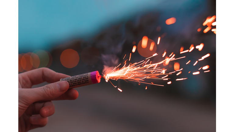 Cropped Image Of Hand Holding Firework