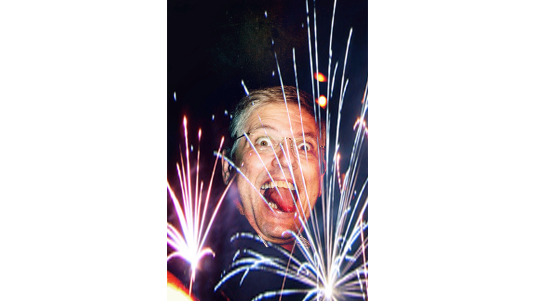 Close-up of funny mature man in front of fireworks