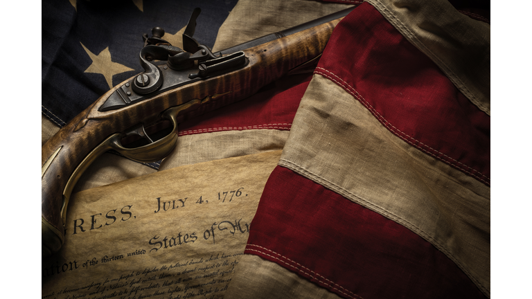 GETTY IMAGES: Flintlock pistol with American flag and Declaration of Independence