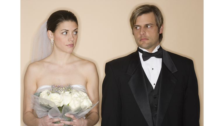 Angry bride and groom looking at each other