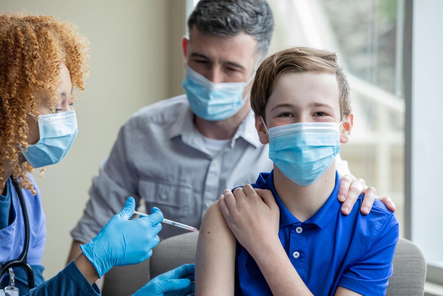 Little boy is finally receiving a COVID-19 vaccine from his pediatrician