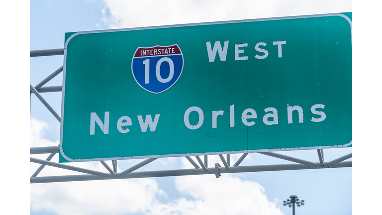 Highway road i10 west interstate 10 with direction sign and text on street for New Orleans in Lousiana with symbol