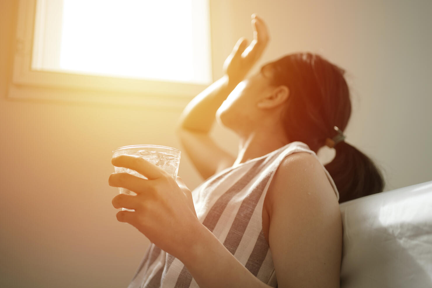 asian female thirsty and dehydration drinking fresh water at summer season at home