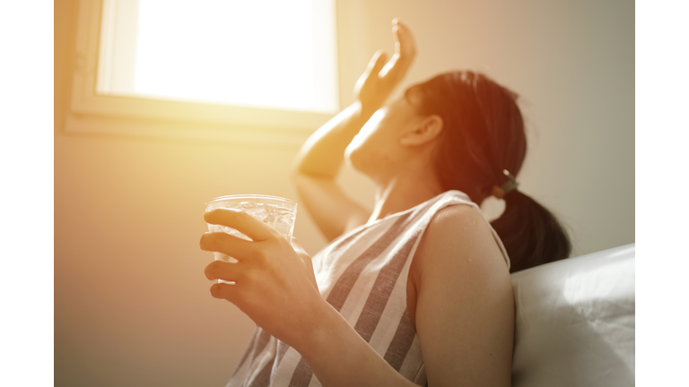 asian female thirsty and dehydration drinking fresh water at summer season at home
