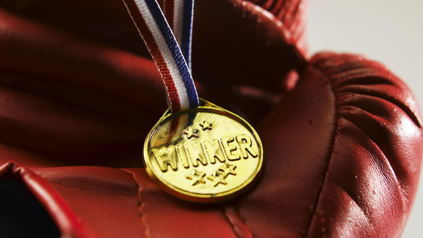 Close-Up Of Boxing Glove With Gold Medal