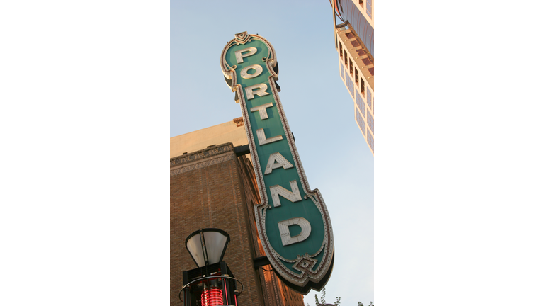 Green sign of Portland spelled vertically in white