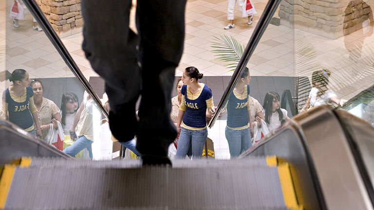 Shoppers walk though Town Center at Aurora, a Simon Property