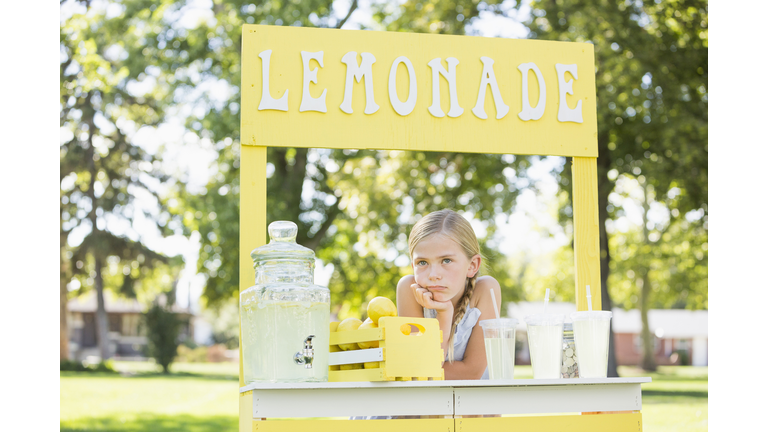 Bored Caucasian girl at lemonade stand