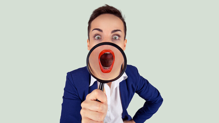 Wow, Big mouth open concept. Closeup cropped Portrait of a young shocked amazed young business woman blue suit  girl, magnifying lens on mouth isolated bright green white background Horizontal image