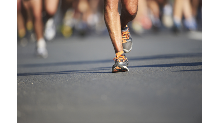 Legs and feet of joggers, running a marathon