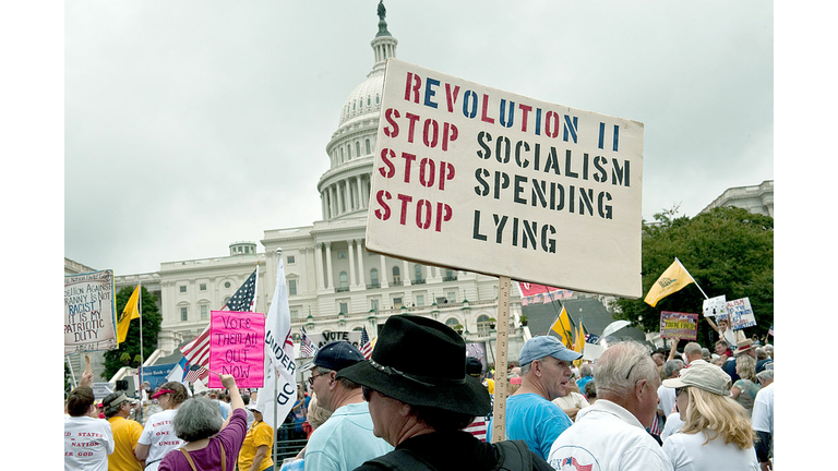 A demonstrator carries a sign calling fo