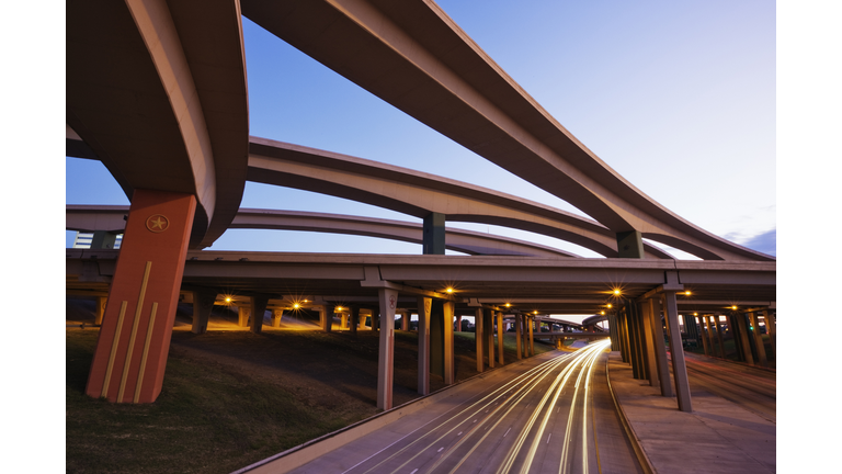 Blurred motion view of traffic driving on highway underpass