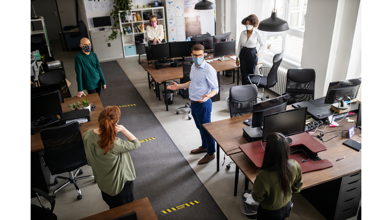 Staff meeting in office with social distancing