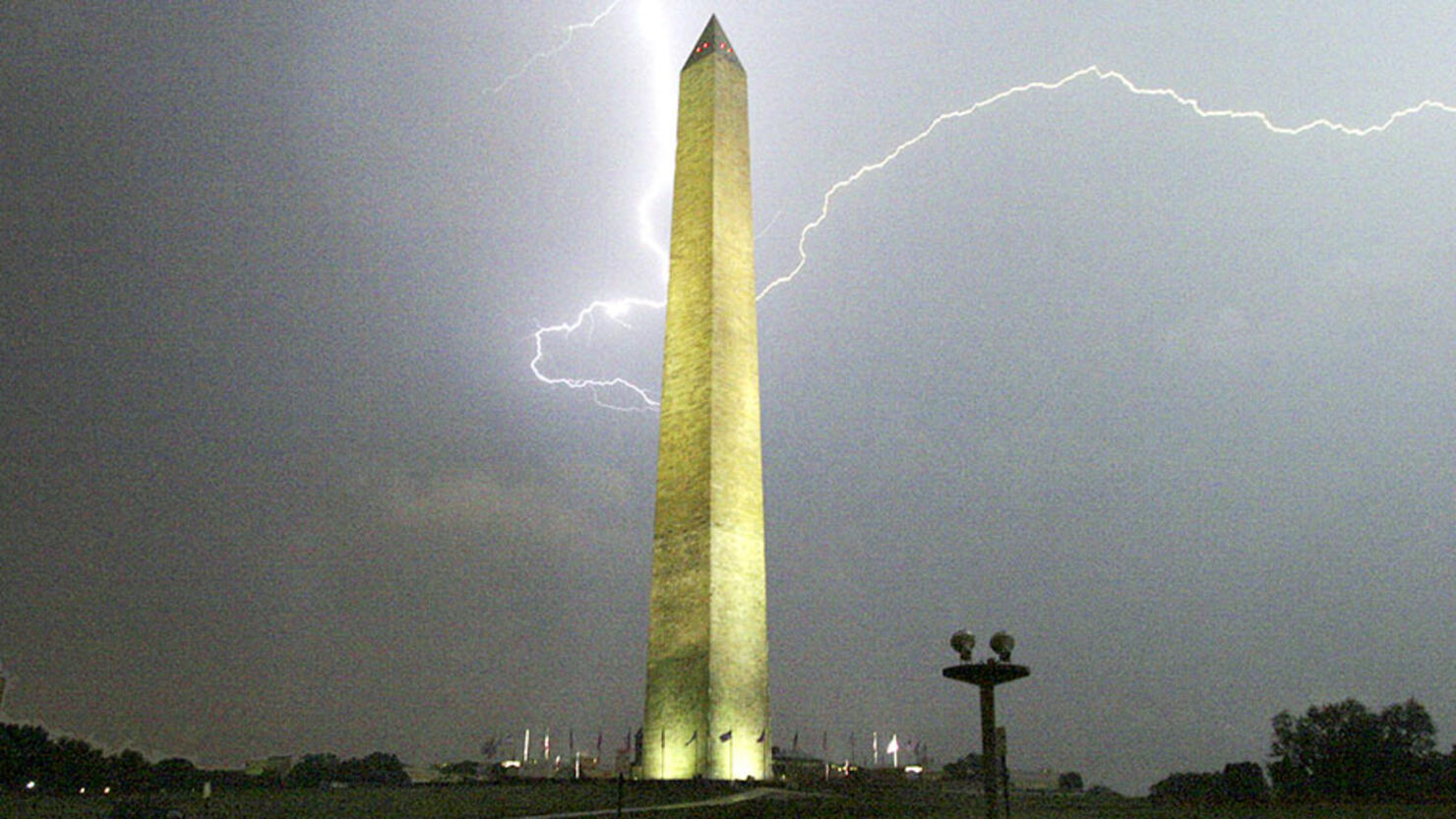 Lightning strikes behind the Washington Monument during a su