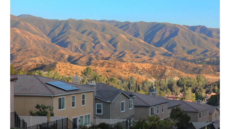 High Angle View Of Houses And Mountains Against Sky