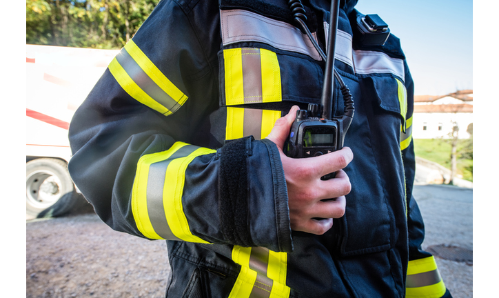 Firefighter using walkie talkie, rescue operation Close Up