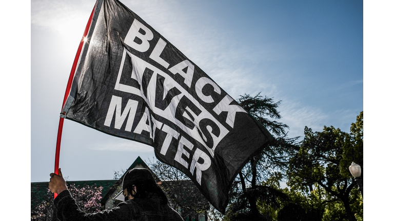 A protester waves a Black Lives Matter flag during the