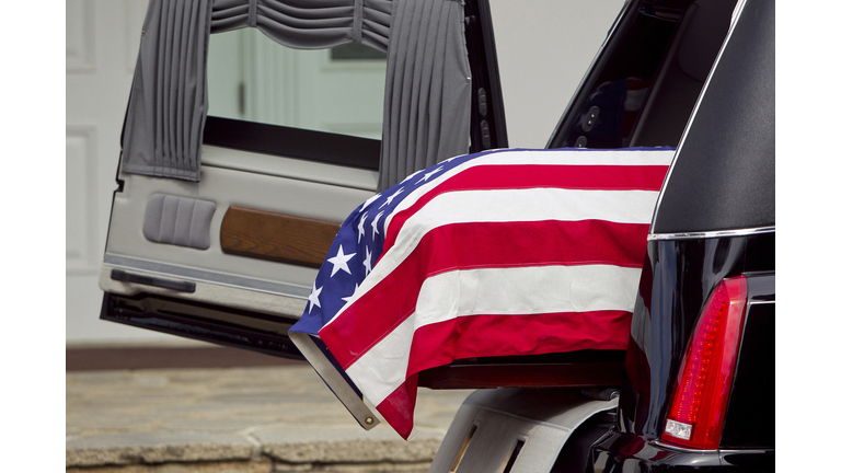 American flag over casket at military funeral