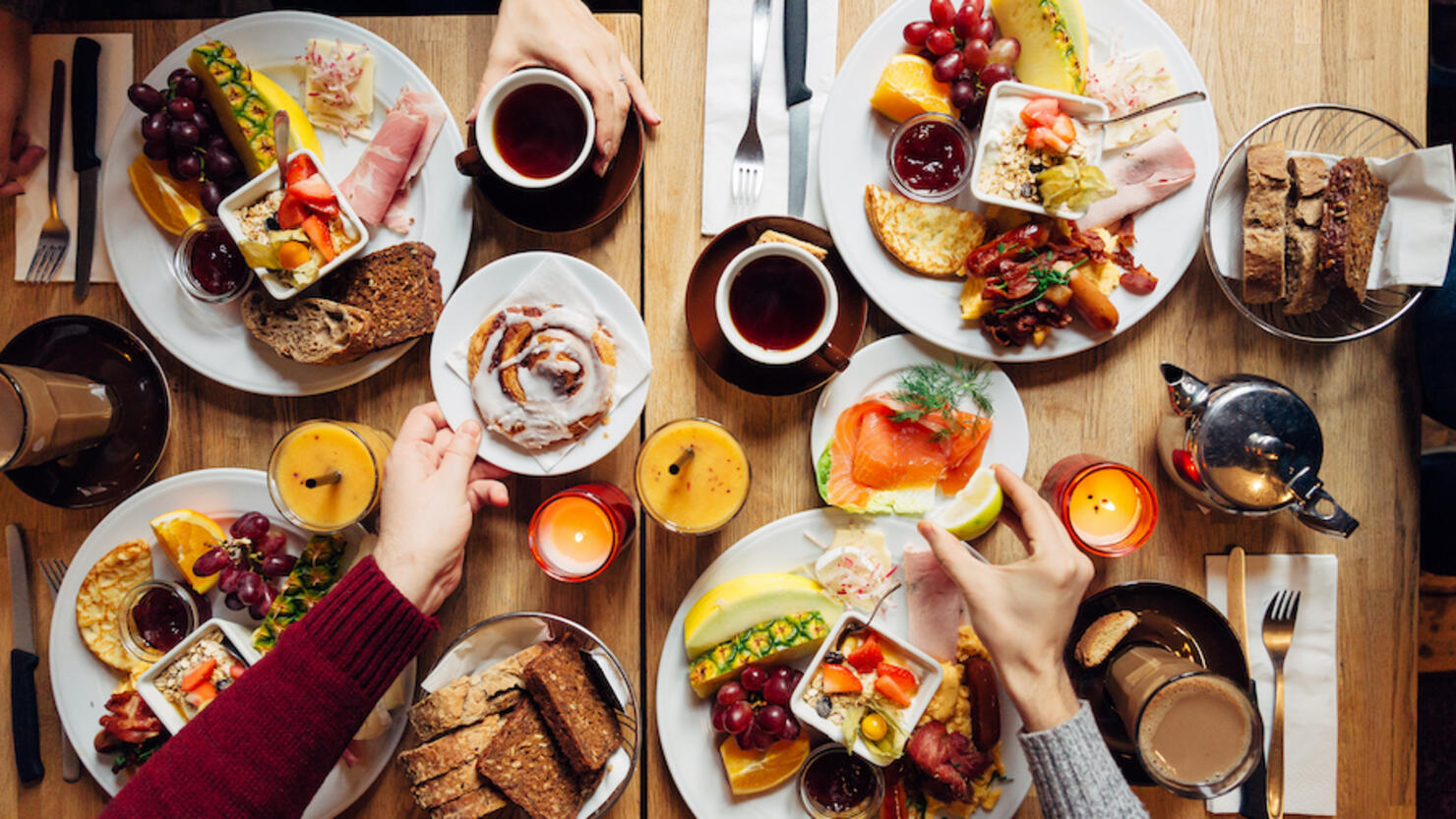 Group of friends having celebration dinner together, directly above view