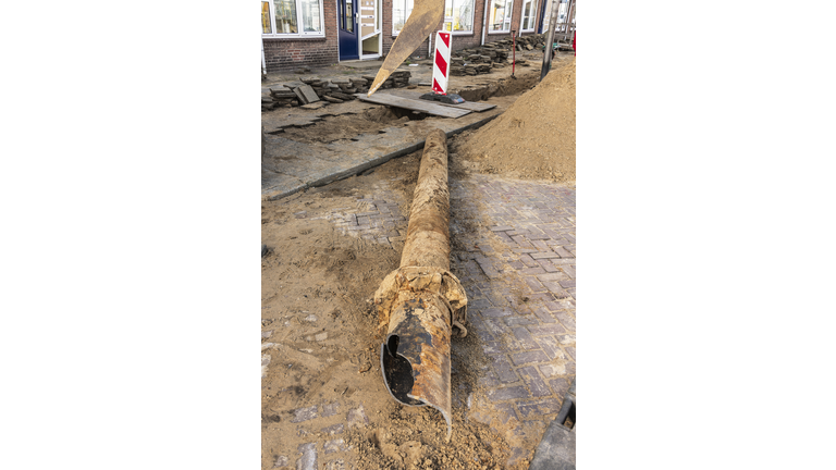 broken sewer pipe lying on the street