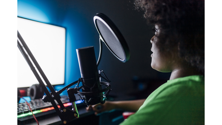 Boy doing online streaming while playing video game at home