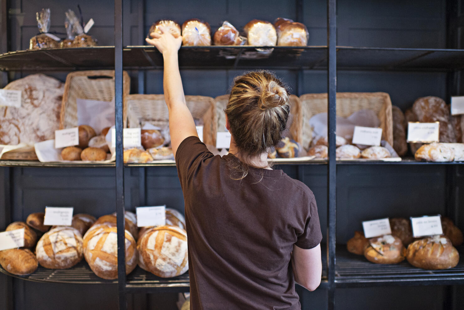 Waitress selecting loaf of bread