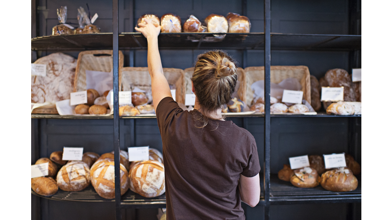 Waitress selecting loaf of bread