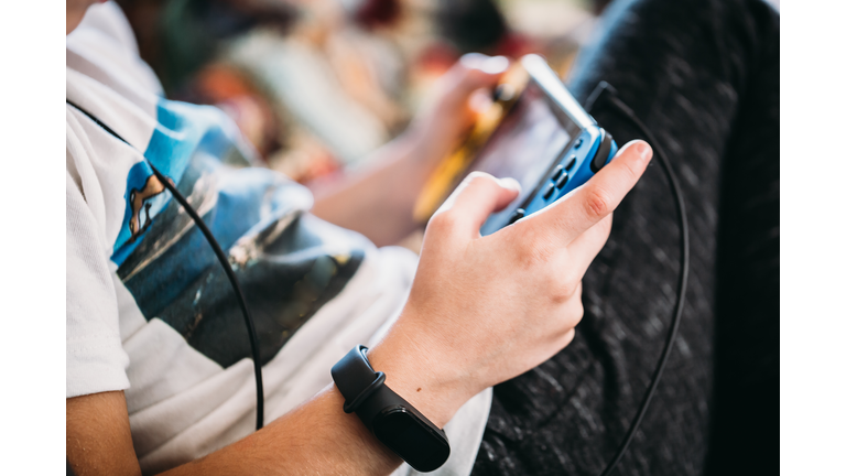 Close up of boy hands with a smart watch playing videogames