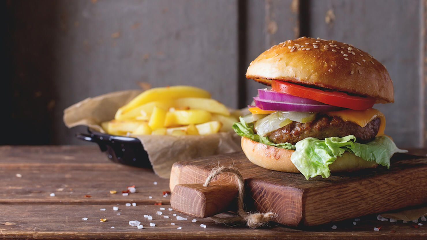 Burger On Cutting Board Over Table