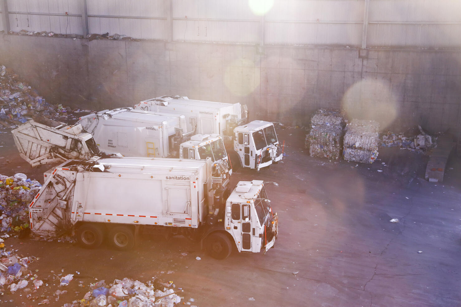 Garbage trucks unloading trash