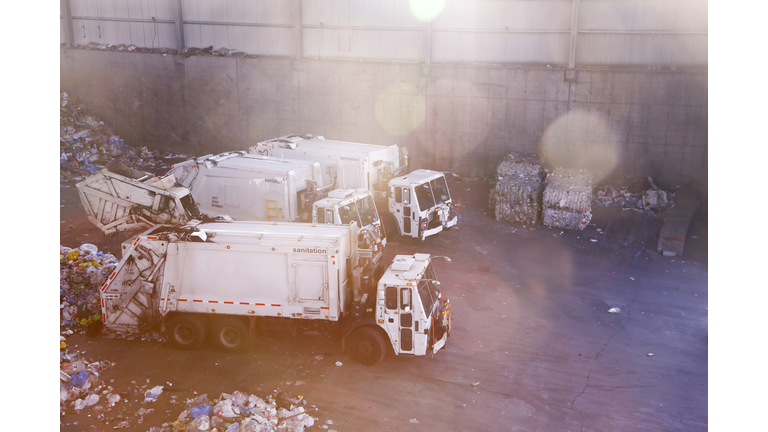 Garbage trucks unloading trash