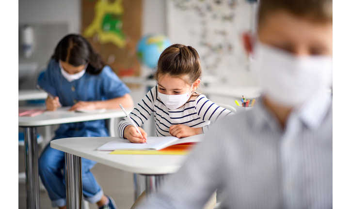 Children with face mask back at school after covid-19 quarantine and lockdown.