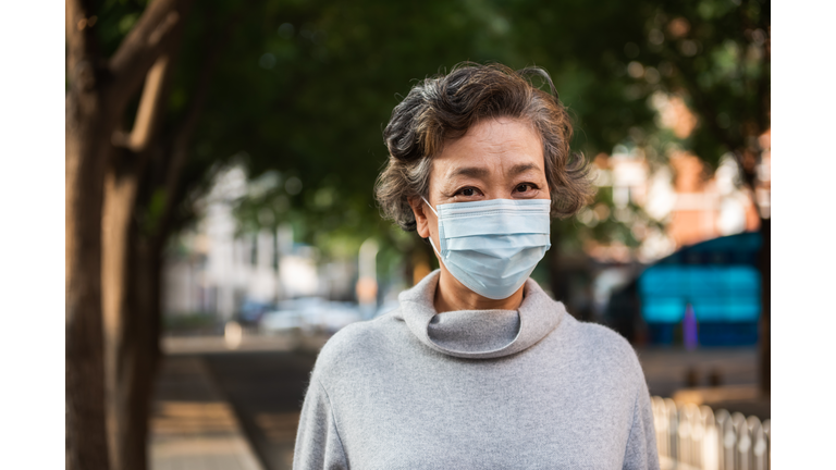 Senior woman wearing a protective mask outdoor, close-up