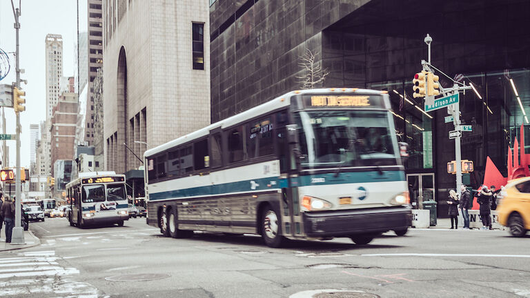 Public transportation buses on Fifth Avenue , Midtown Manhattan