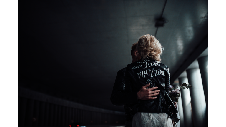 Rear View Of Woman Standing Against Wall
