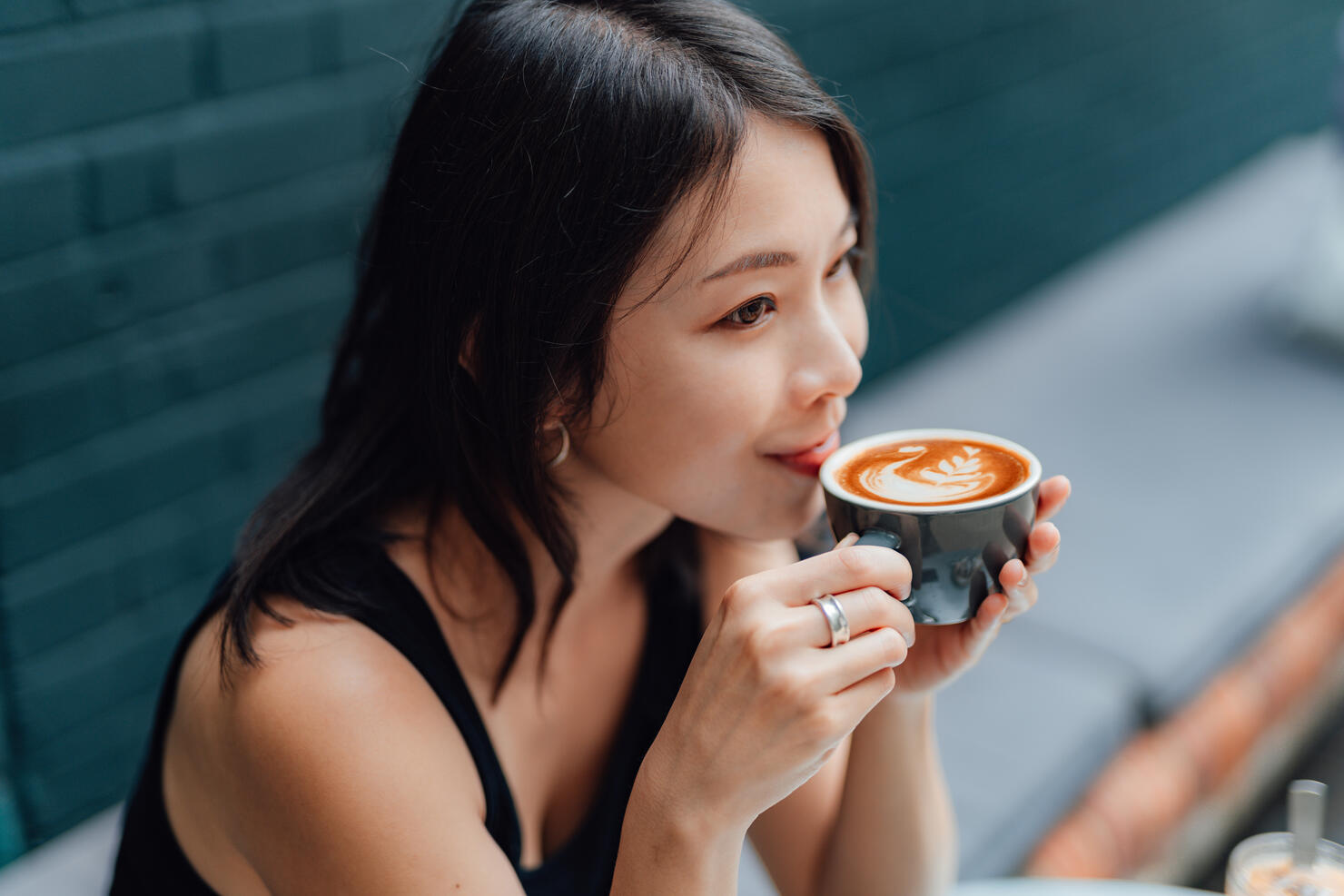 Young woman enjoying a peaceful morning with a cup of coffee in cafe