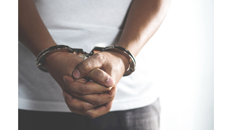 Handcuffed prisoner in jail