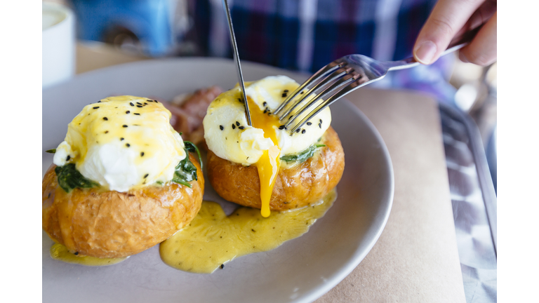 Close up of Eggs Benedict with liquid egg yolk running out