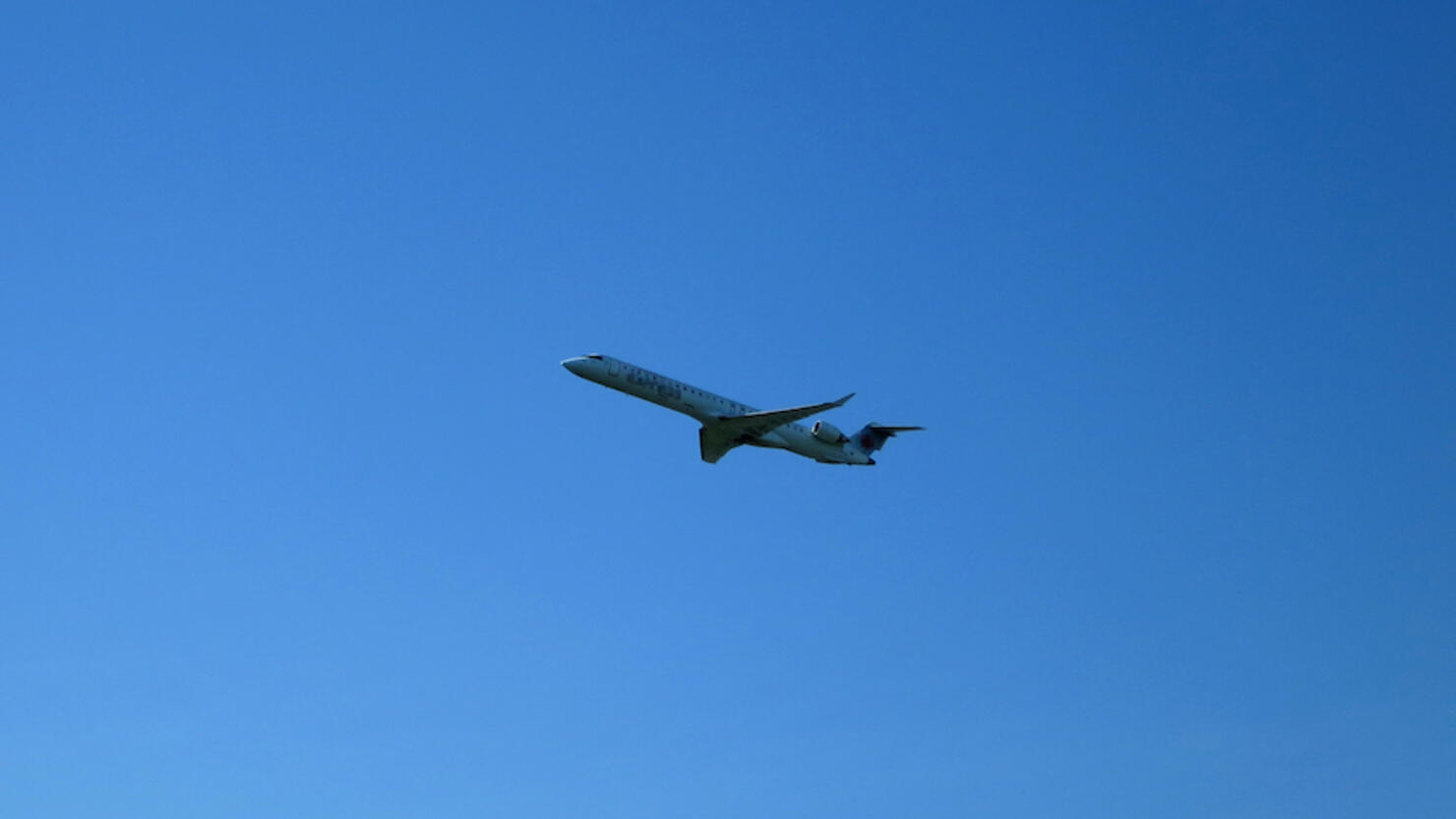 Mid-sized Regional Jet Taking Off against Blue Sky