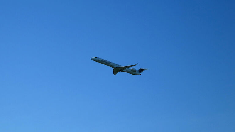 Mid-sized Regional Jet Taking Off against Blue Sky