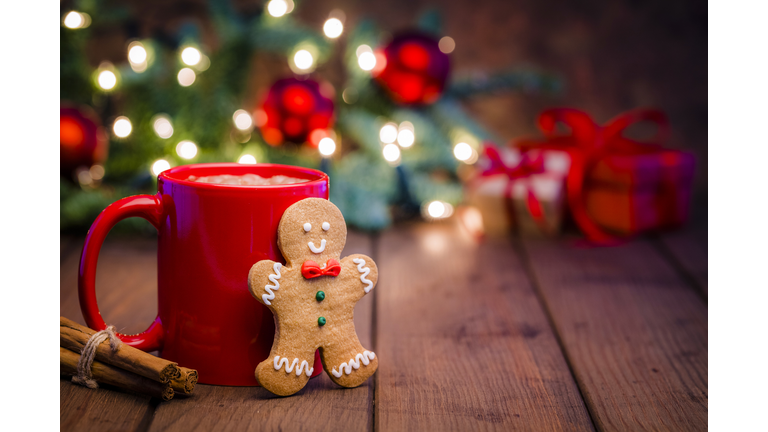 Homemade hot chocolate mug and gingerbread cookie on Christmas table