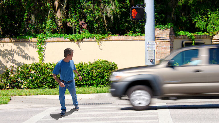 Jaywalking man about to be run over by truck