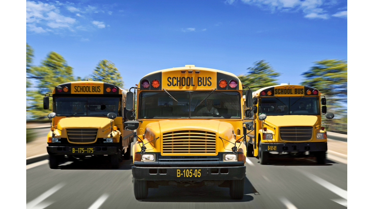 Three school buses driving towards camera