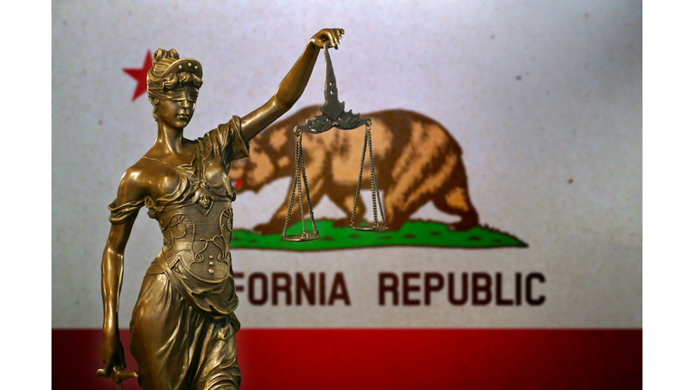 Lady Justice before a flag of California