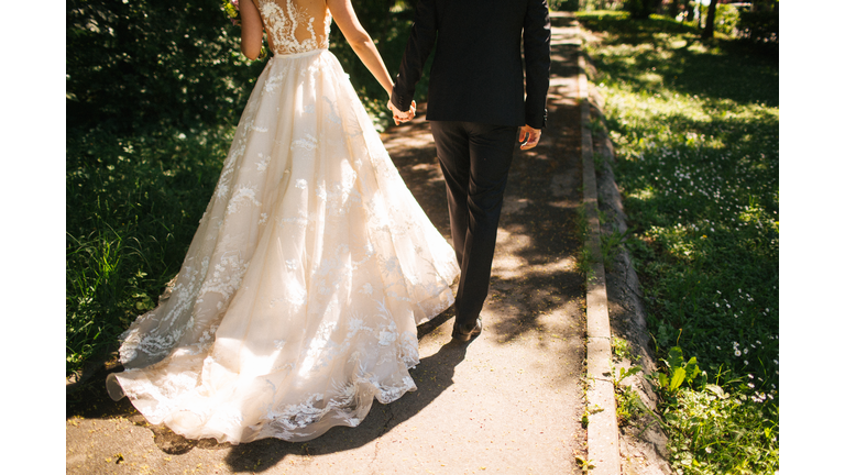 Bride and groom walking on pavements