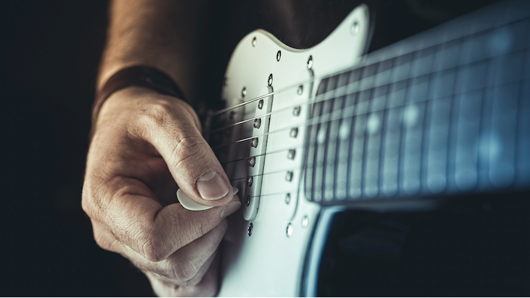 Young man playing electric guitar