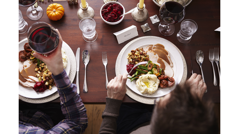 Overhead of two men eating holiday meal