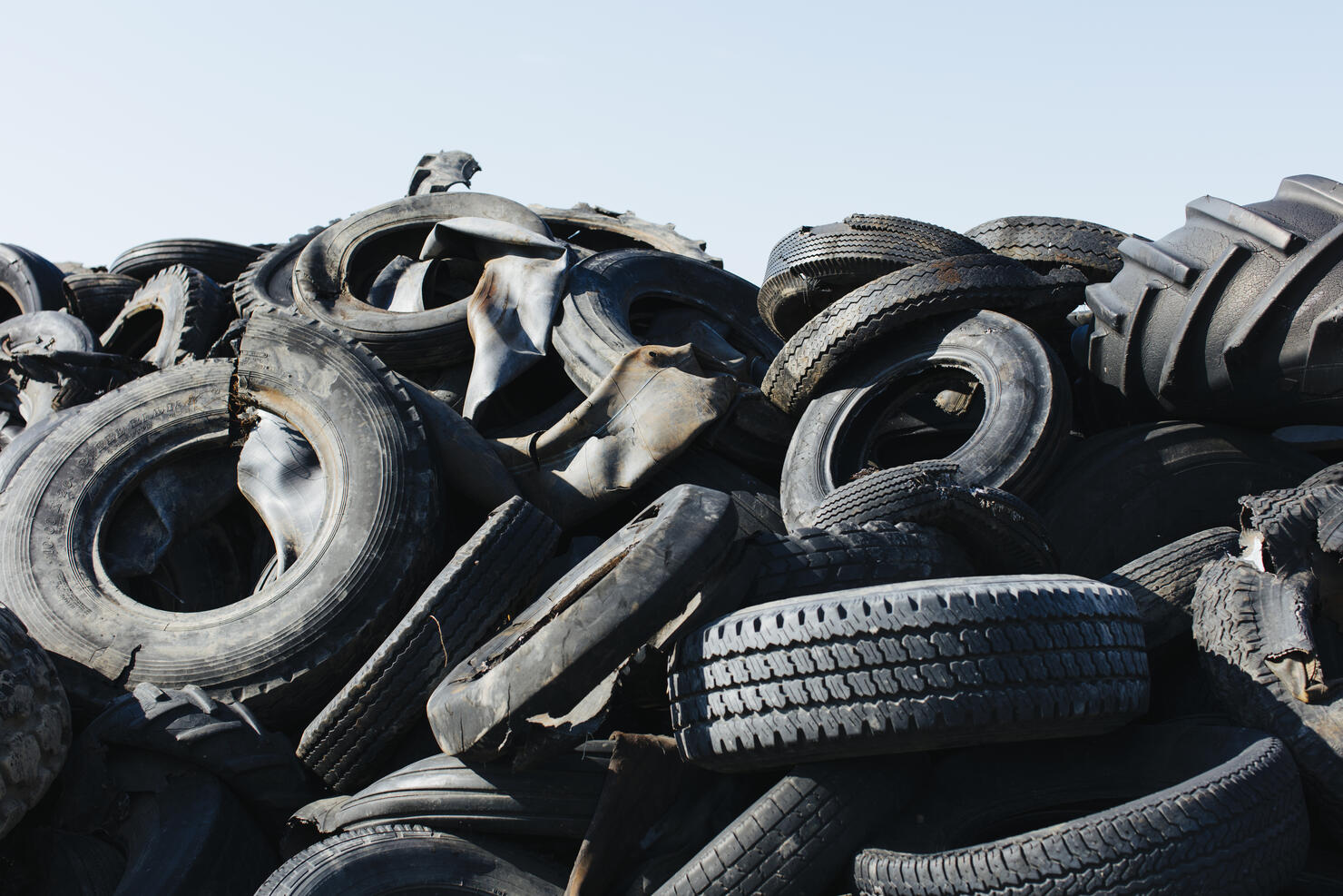 Pile of discarded auto and tractor tires in rural landfill, abandonned farms