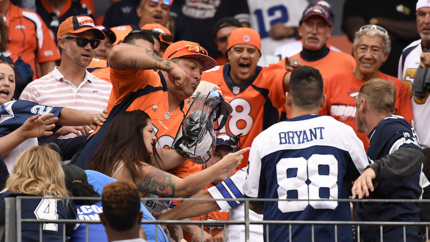 A Cowboys fan fights Eagles fan in the stands